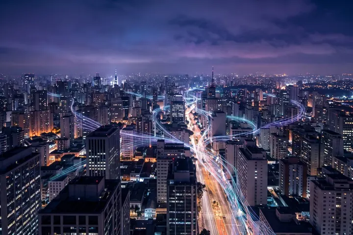 São Paulo at night from above, with beams of light between skyscrapers