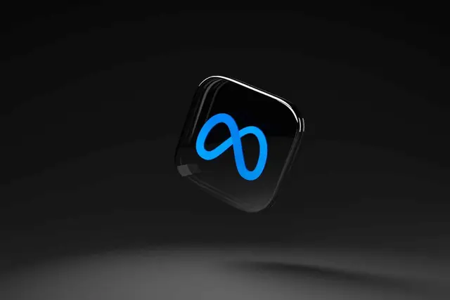 Blue Meta logo, a glowing infinity loop, on a black rounded-corner icon floating against a dark background