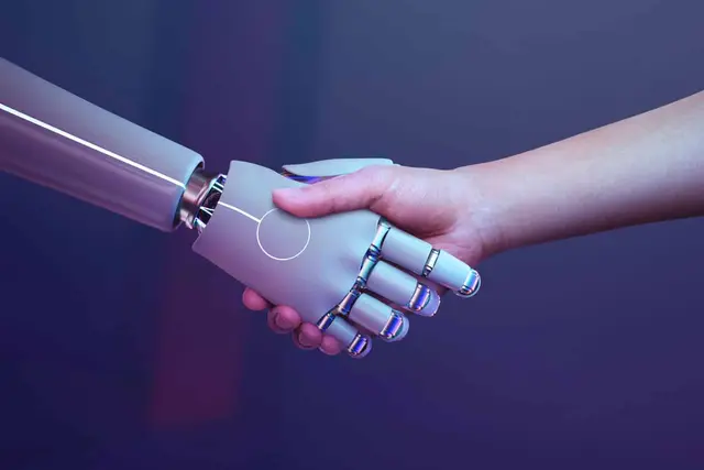A handshake between a silver robotic hand and a human hand against a dark purple background