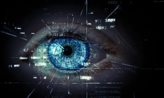 Human eye with a blue iris overlaid with lines of code and digital symbols on a dark background
