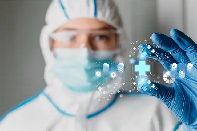 Researcher in protective suit, mask and blue gloves holds a glowing medical symbol surrounded by icons in front of the camera.