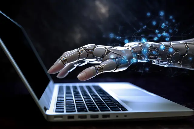Metallic robotic hand reaching toward a laptop keyboard, with blue sparks, a symbol of creative AI.
