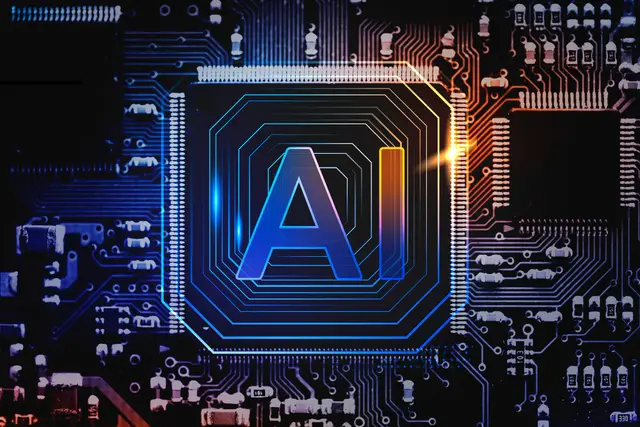 Glowing chip with the letters AI at the center of a dark circuit board in blue and orange tones.