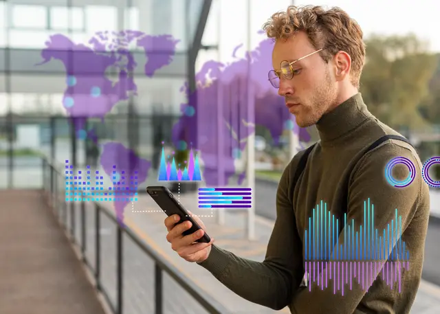 Man with glasses looking at his phone while world maps and data graphics in shades of purple are overlaid on the image