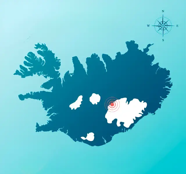 Stylized map of an island in dark blue on a light blue background, with a compass and a red dot on a white area