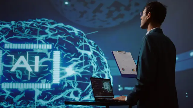 Man in a suit with a laptop and a clipboard looks at a huge glowing brain with the letters AI projected on a screen