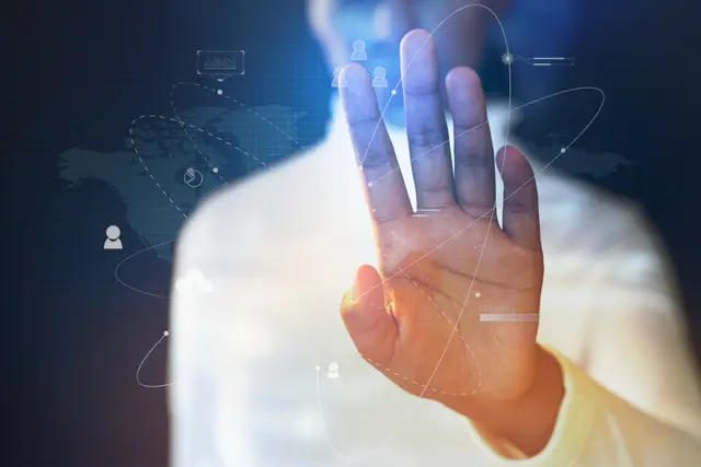 Open hand raised in a stop gesture in front of network icons and a faint world map, an image of the warning about AI risks