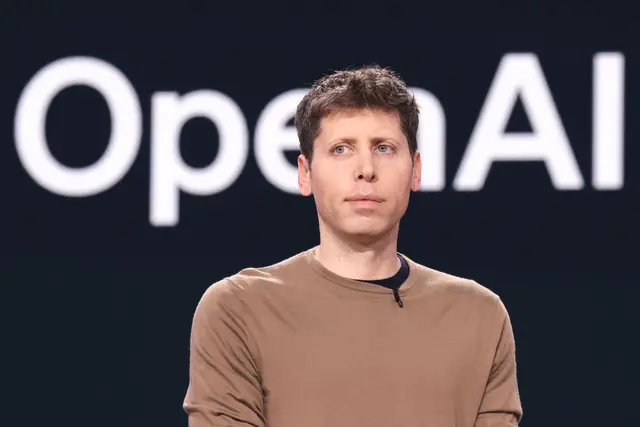 Sam Altman in a brown shirt against a dark background with the OpenAI logo