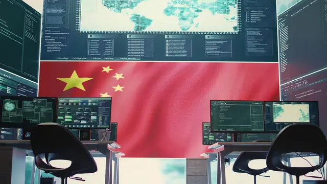Control room with empty chairs, screens showing maps and data, and a large Chinese flag in the background