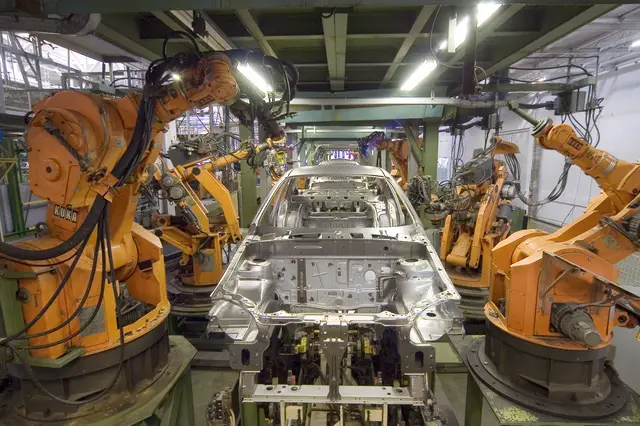 KUKA industrial robots working on an automotive manufacturing line